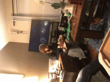 two people sitting on a couch in front of a tv