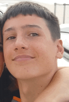 a close up of a young man 's face and neck