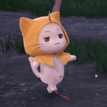 a white cat wearing a yellow cat hat is walking in the grass
