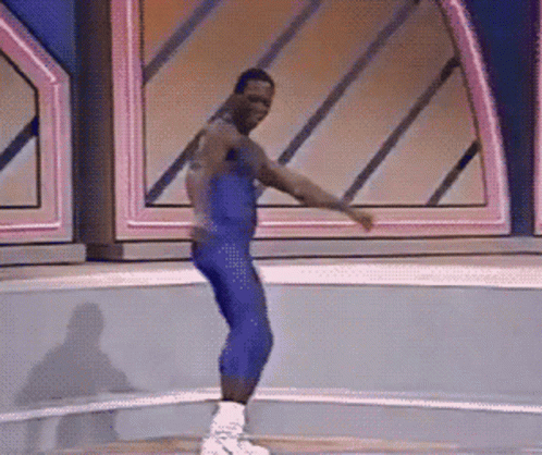 A silly mid-aged man wearing blue leather spandex dancing and sprinting in place