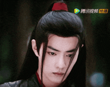 a close up of a man 's face with chinese characters on the bottom