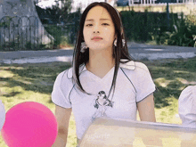 a girl wearing a white shirt with a picture of a woman on it