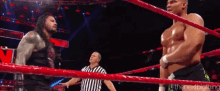 two wrestlers are standing in a ring with a referee and the words " the next big thing " on the bottom