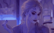 a woman is wearing a purple wig and a purple dress .