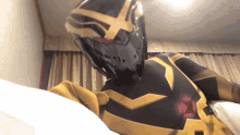 a person in a black and gold superhero costume