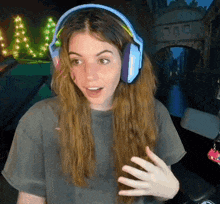 a woman wearing headphones and a gray shirt
