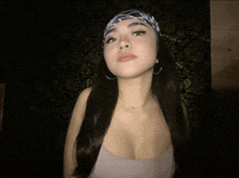 a woman wearing a bandana on her head and a necklace