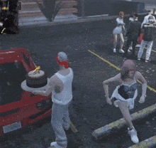 a man in a bandana holds a birthday cake in front of a red car