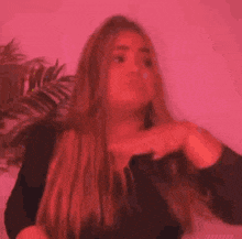 a woman with long blonde hair is wearing a black top