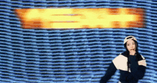 a woman stands in front of a screen that says eee