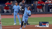 a blue jays baseball player throws a ball in the air