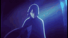 a man in a black cape is standing in a dark room in front of a blue light .