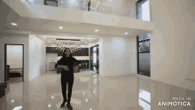 a woman is standing in a large empty room with the words made in animotica below her
