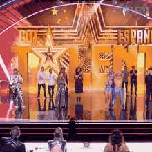 a group of people standing in front of a stage that says got span