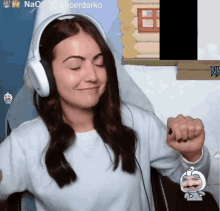 a woman wearing headphones is sitting in front of a screen that says amberdarko