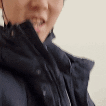 a close up of a person wearing a helmet and a black jacket