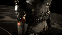a man in a costume is holding two guns in his hand .