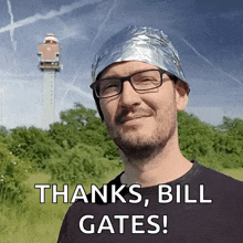a man wearing a tin foil hat with the words thanks bill gates below him