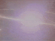 a blurry picture of a person in a dark room with a purple background