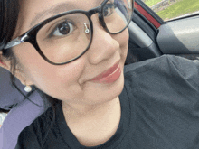 a woman wearing glasses has a piercing in her nose