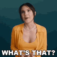 a woman in a yellow shirt and necklace is asking what 's that