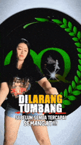 a woman is dancing in front of a green logo that says dilarang tumbang