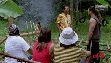 a group of people are gathered in the woods and the word astro is on the bottom right