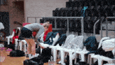 a female basketball player is getting ready for a game in a locker room