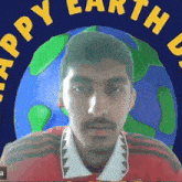 a man wearing a red shirt with the words happy earth on the bottom