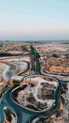 an aerial view of a city with a flag on a pole in the middle