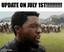 a man with a beard is standing in a field with a group of people .