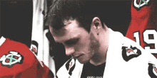 a hockey player wearing a black shirt with the number 19 on it