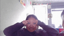 a girl making a funny face in front of a wall that says exit