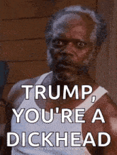 a man with a beard is wearing a white tank top and says " trump you 're a dickhead "