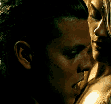 a close up of a man and woman 's faces