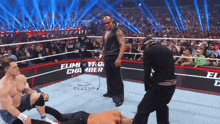a wrestling match takes place in a ring that says elimination chamber on it
