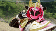 a pink and gold samurai holding a sword and a watch