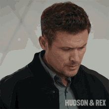 a close up of a man 's face with the words hudson & rex in the corner