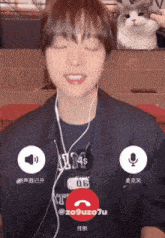 a man wearing ear buds and a shirt that says aim on it