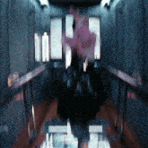 a blurry image of a person in an elevator with a reflection