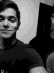 a black and white photo of a man taking a selfie .