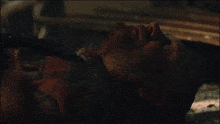 a man with a beard is laying on the ground with his eyes closed