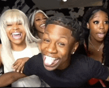 a group of people are laughing and making funny faces .