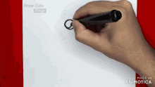 a person is drawing a circle with a marker on a piece of paper