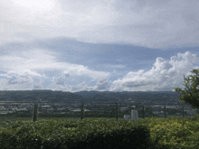 a view of a city from a balcony with mountains in the distance
