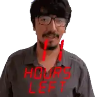 a man with glasses and a shirt that says hours left on it