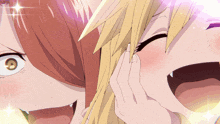 a girl with red hair and a girl with blonde hair are laughing