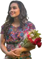 a woman in a colorful dress holding a bouquet of flowers