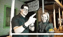 a man and a woman standing in front of a sign that says valley museum