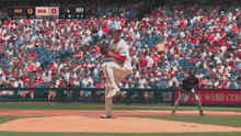 a pitcher winds up to throw a pitch during a baseball game between pittsburgh and phillies